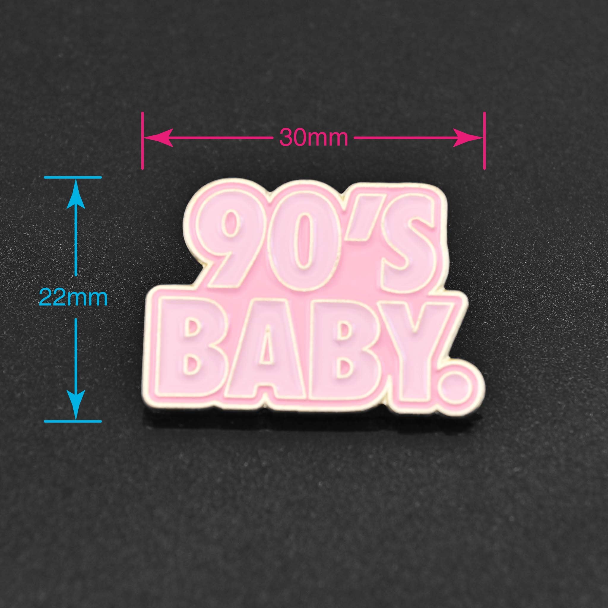 A pink enamel pin that says 90's Baby - perfect for the Millennial in your life 