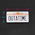 An enamel pin of the Outatime license plate of the Back to the Future Delorean time machine
