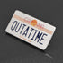 An enamel pin of the Outatime license plate of the Back to the Future Delorean time machine