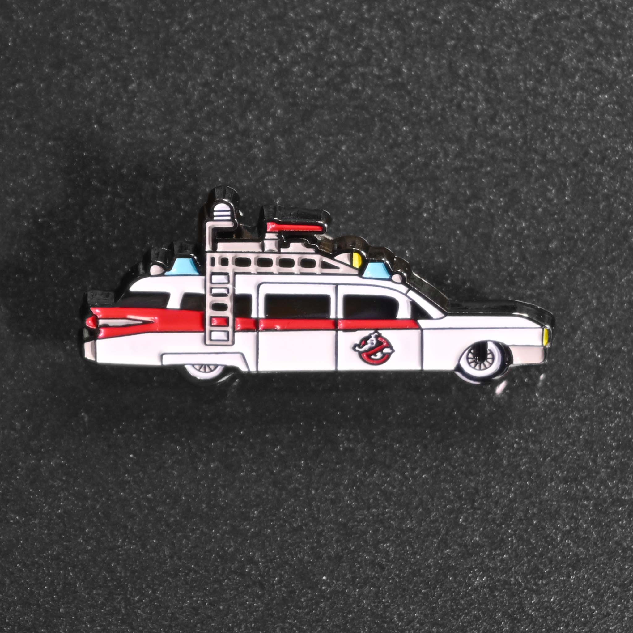 A cute enamel pin of the 1980s Ghostbusters car ECTO-1