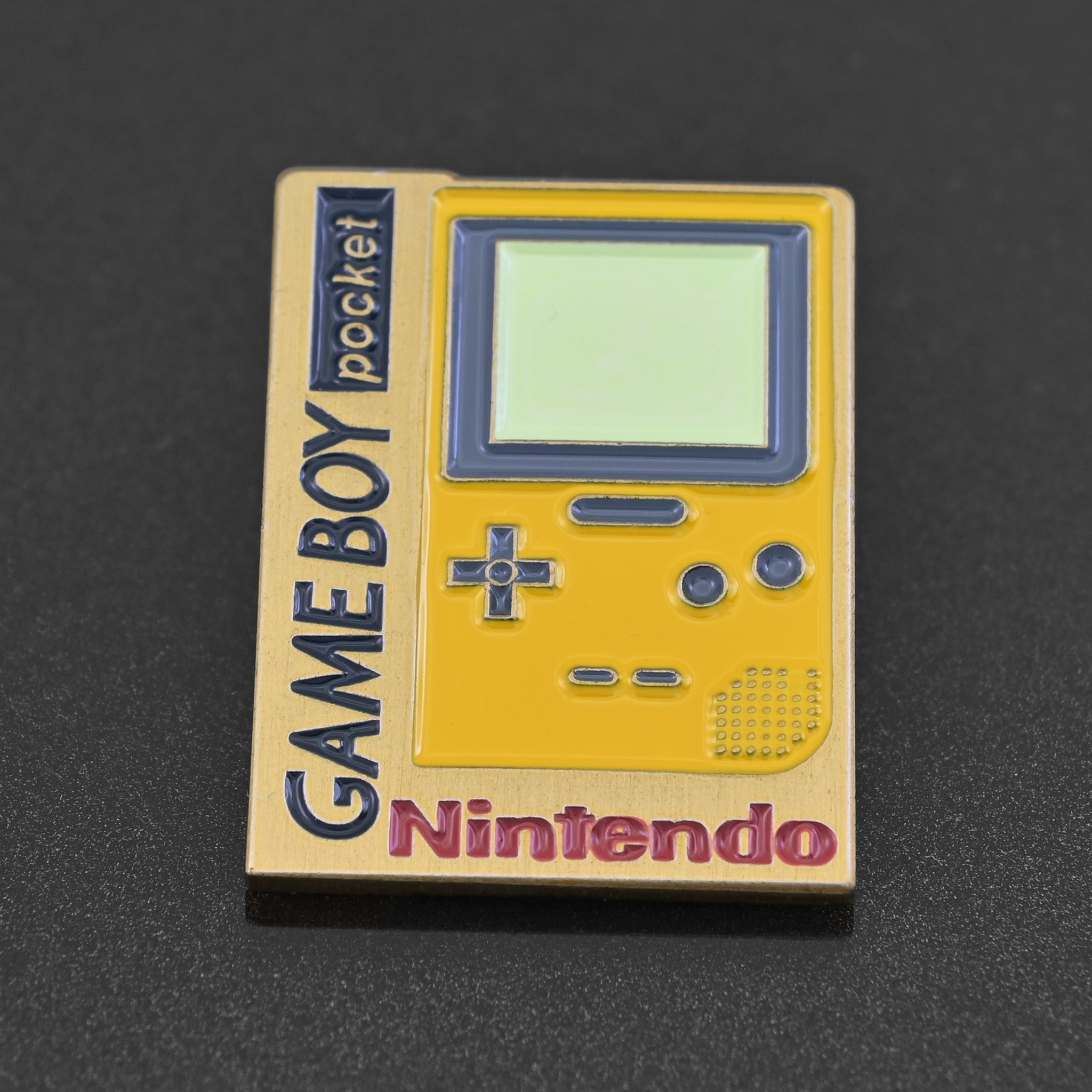 an enamel pin featuring the Nintendo Game Boy