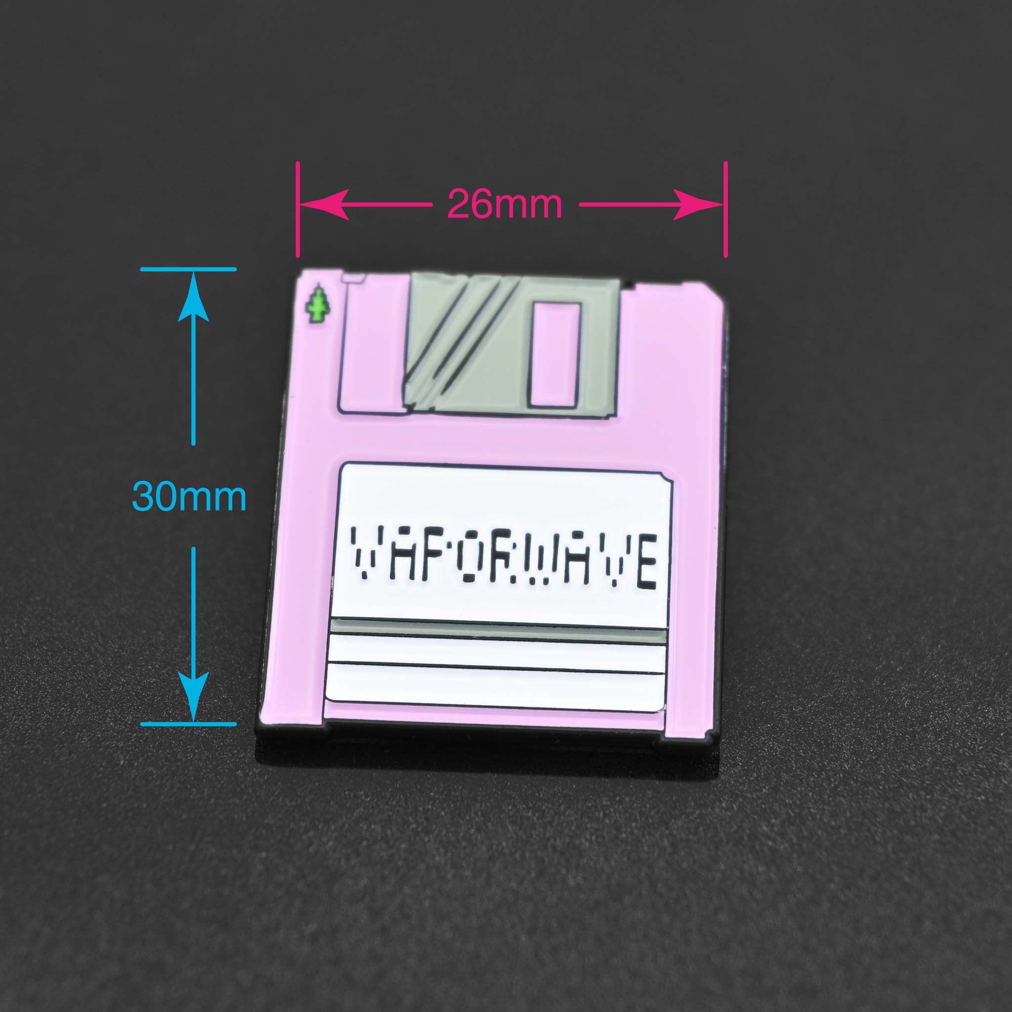 Enamel pin of a pink disk with a label of Vaporwave. 