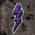 Prismatic or holographic purple sticker in neon colors and in the shape of the lightning bolts we used to draw in our schoolbooks back in the 80s and 90s